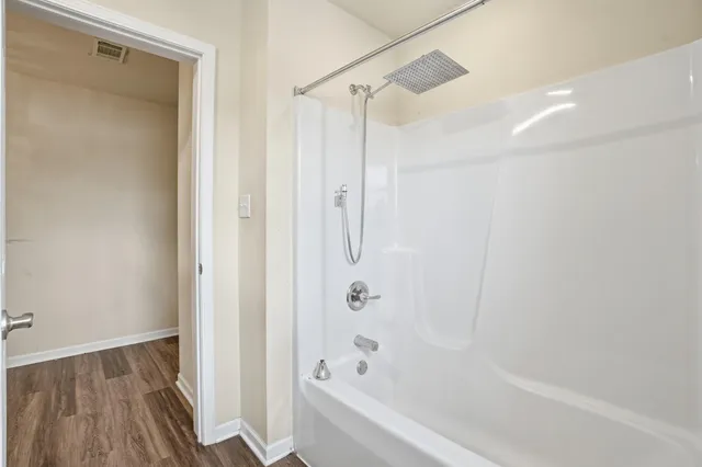 a bathroom with a bathtub and a shower