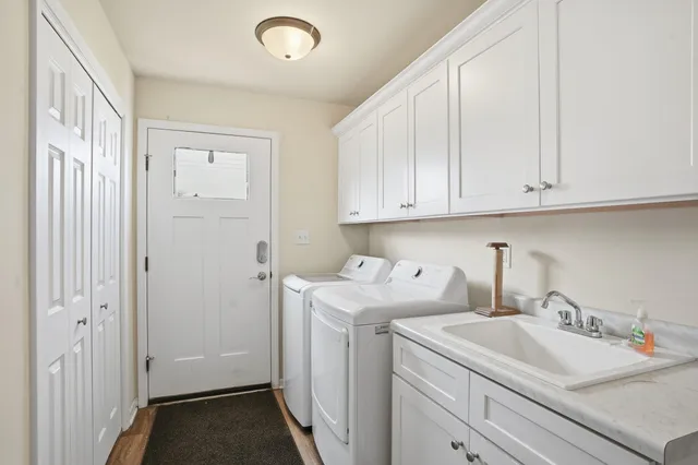 a view of a storage and utility room with sink washer and dryer
