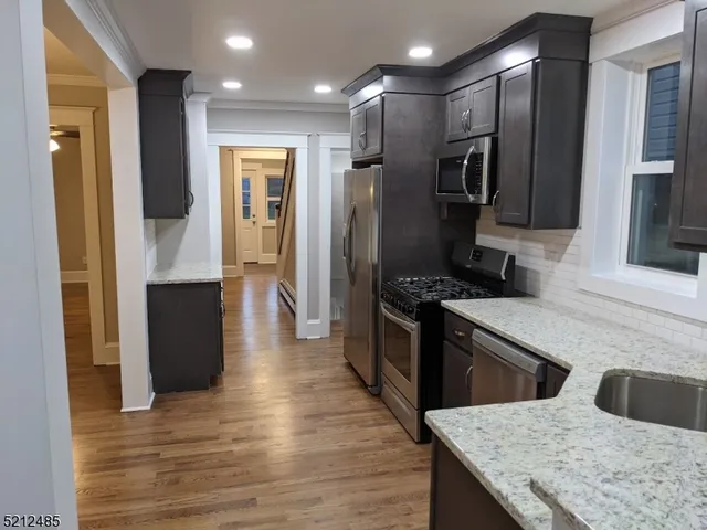 a kitchen with a refrigerator and a sink