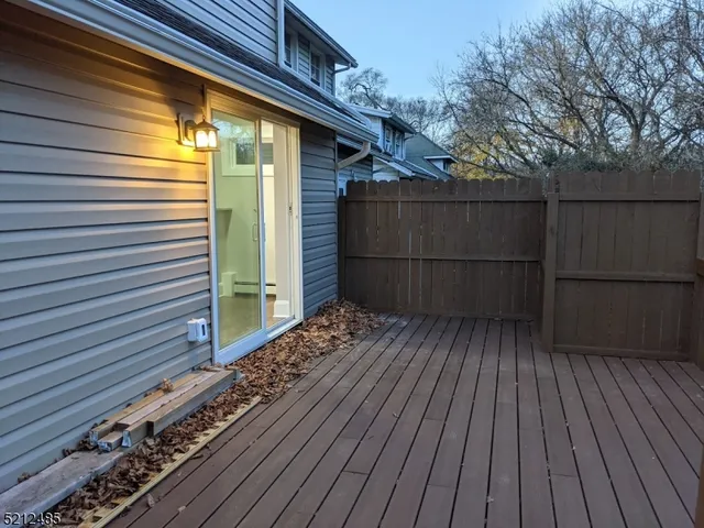 a view of a house with a wooden deck