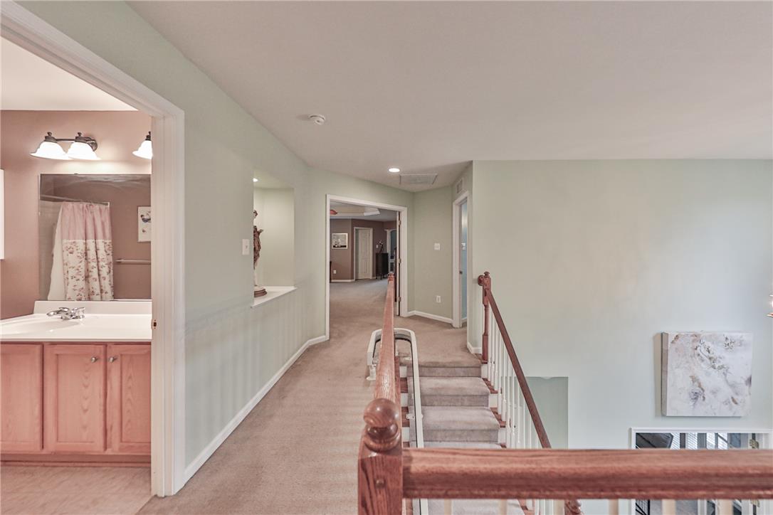 138 Clover Hollow Road Easton, PA 18045 - Photo 57 of 95 A well-lit landing and hallway lead to a bright bathroom and additional living spaces.