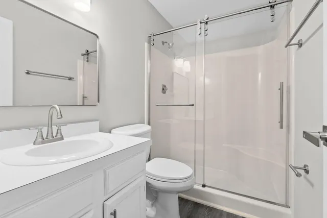 a bathroom with a sink toilet and shower