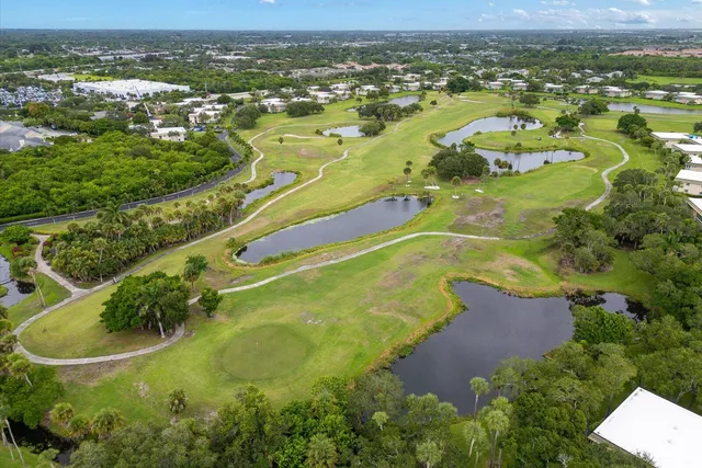 an aerial view of residential houses with outdoor space and river