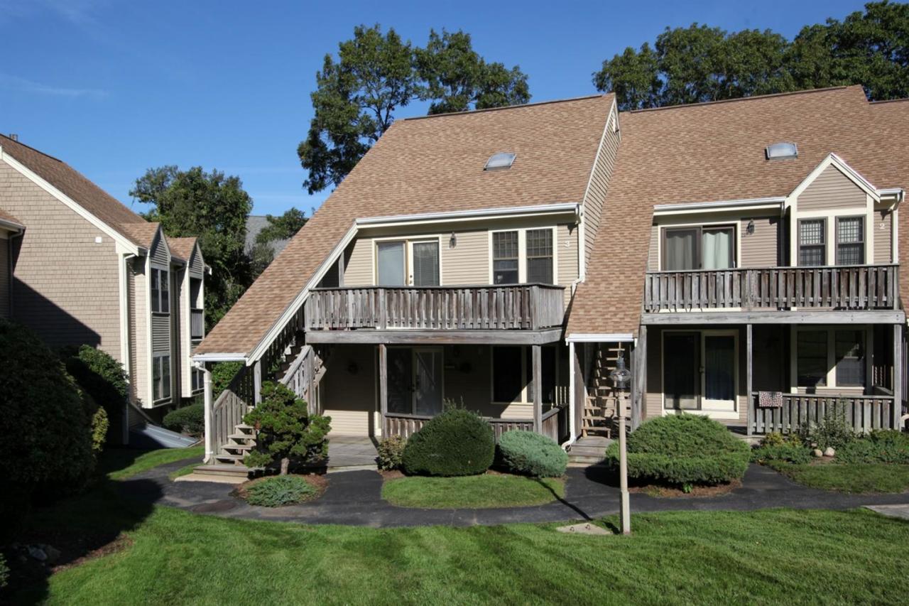817 Old Strawberry Hill Road, Unit 3B Centerville, MA 02632 - Photo 1 of 9 a aerial view of a house next to a yard