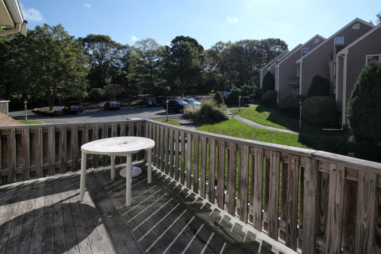 817 Old Strawberry Hill Road, Unit 3B Centerville, MA 02632 - Photo 2 of 9 a view of balcony with wooden floor and outdoor seating
