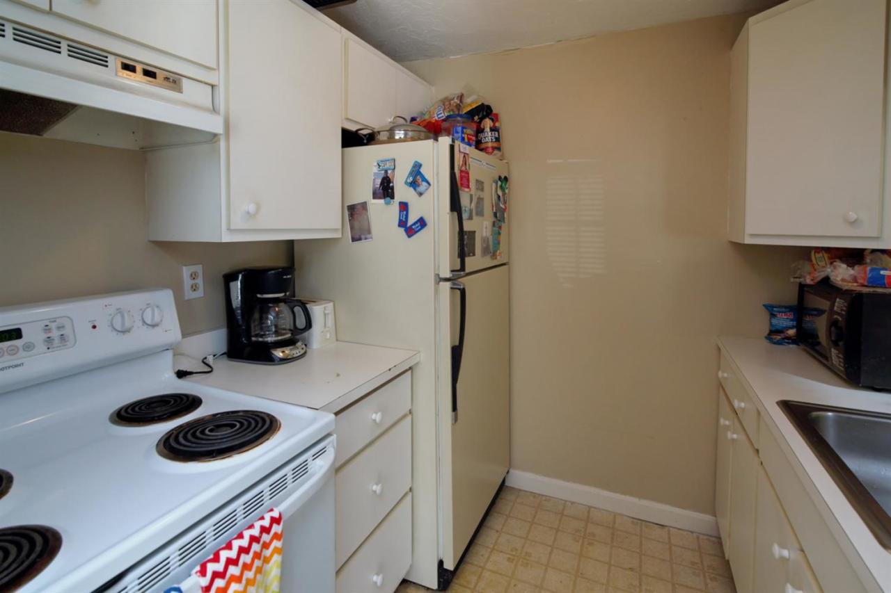 817 Old Strawberry Hill Road, Unit 3B Centerville, MA 02632 - Photo 5 of 9 a kitchen with a refrigerator and a stove top oven