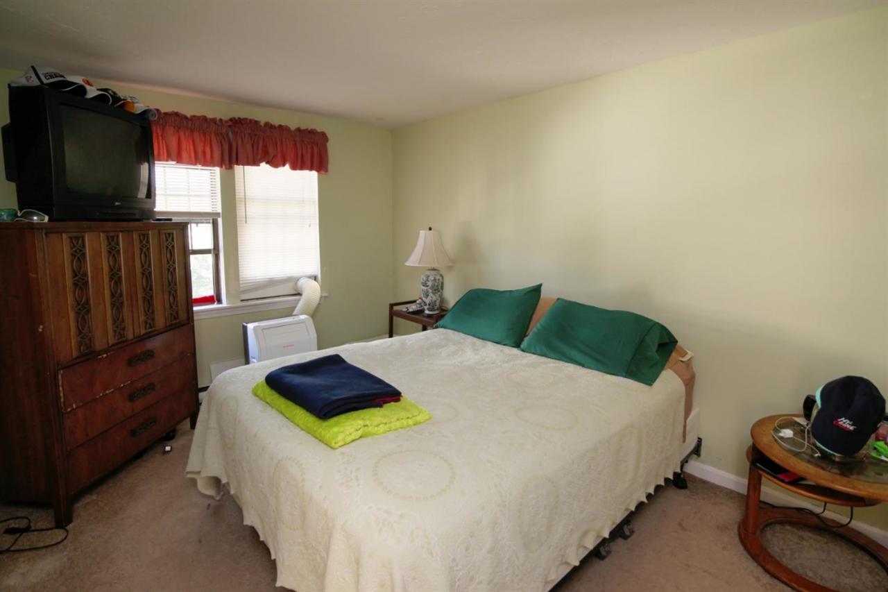 817 Old Strawberry Hill Road, Unit 3B Centerville, MA 02632 - Photo 6 of 9 a bedroom with a bed and flat tv screen on the dresser
