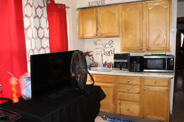 a room with a chandelier furniture and a ceiling fan