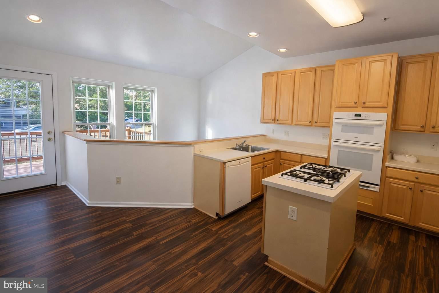 43 Bank Spring Court Owings Mills, MD 21117 - Photo 13 of 20 a kitchen with a stove a sink and wooden floor