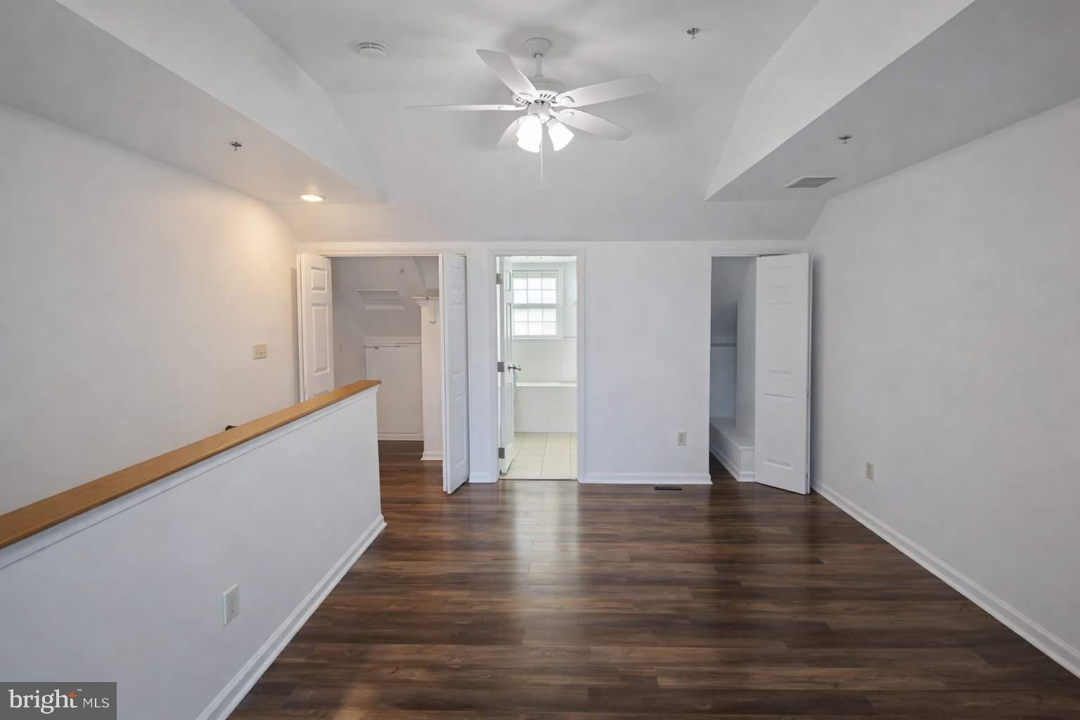 43 Bank Spring Court Owings Mills, MD 21117 - Photo 16 of 20 a view of an empty room with wooden floor and a ceiling fan