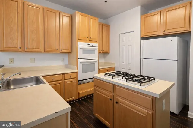 a kitchen with a stove and a refrigerator