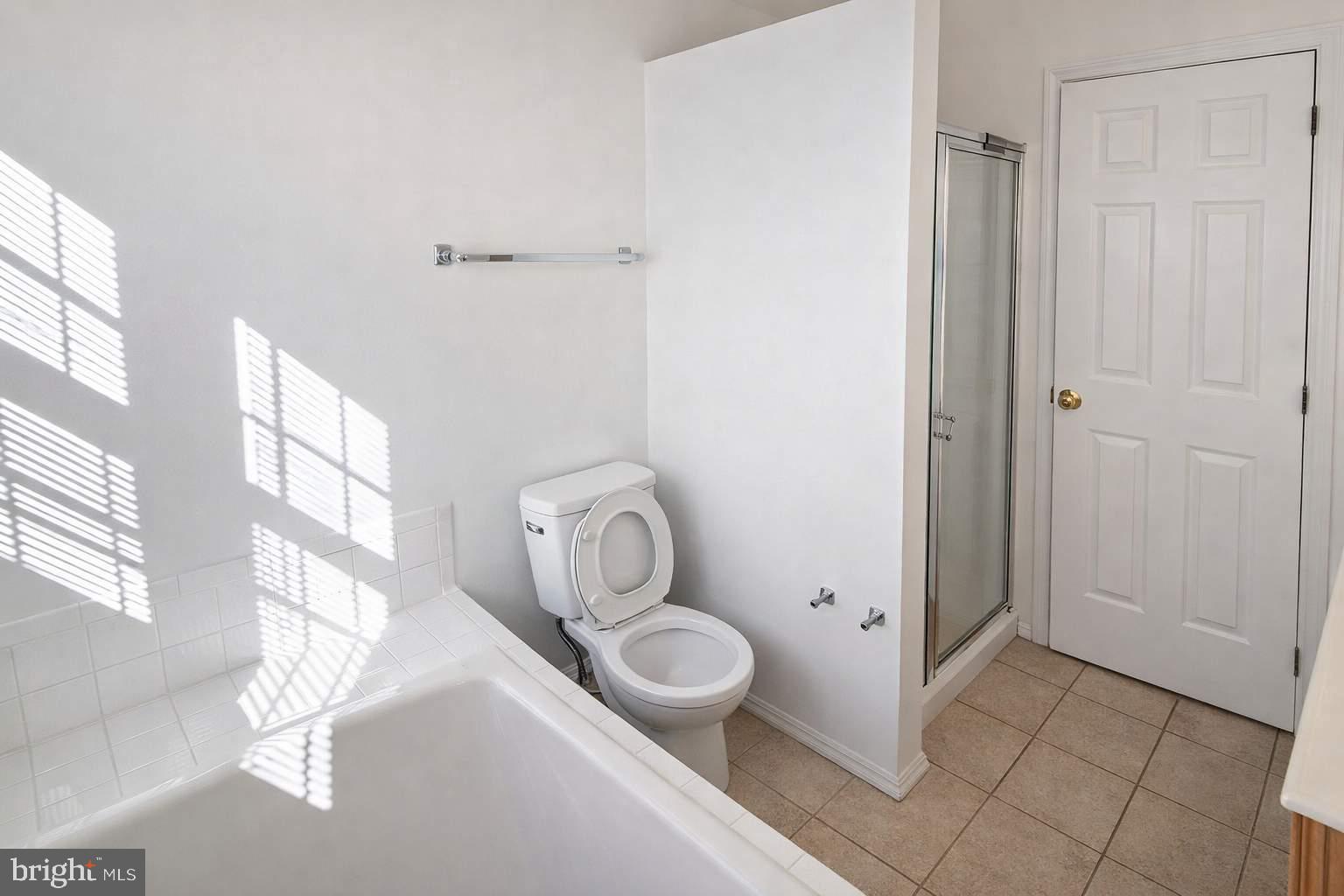 43 Bank Spring Court Owings Mills, MD 21117 - Photo 6 of 20 a bathroom with a granite countertop toilet and a sink
