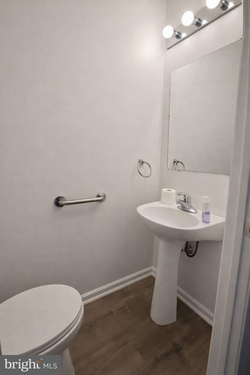 43 Bank Spring Court Owings Mills, MD 21117 - Photo 8 of 20 a bathroom with a sink toilet and a mirror