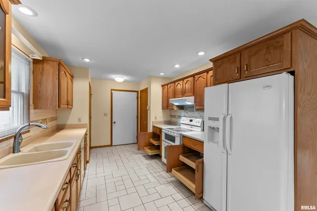 a kitchen with stainless steel appliances a refrigerator and a sink