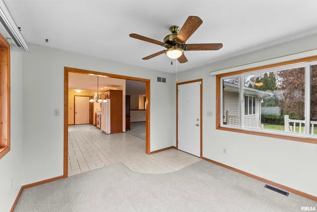 a view of a livingroom with a ceiling fan and window