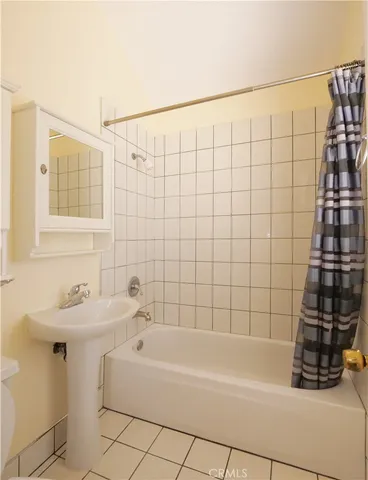 a bathroom with a bathtub and shower
