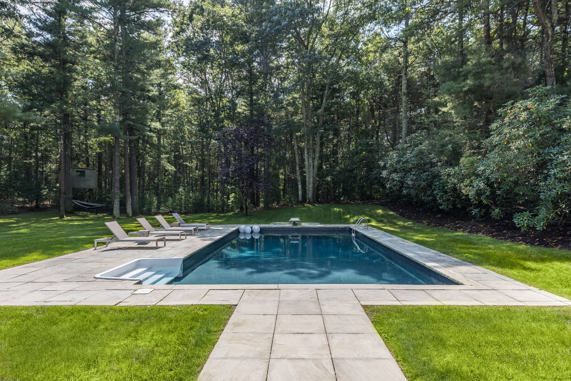 52 Bull Path East Hampton, NY 11937 - Photo 3 of 24 a view of a swimming pool with a lounge chair