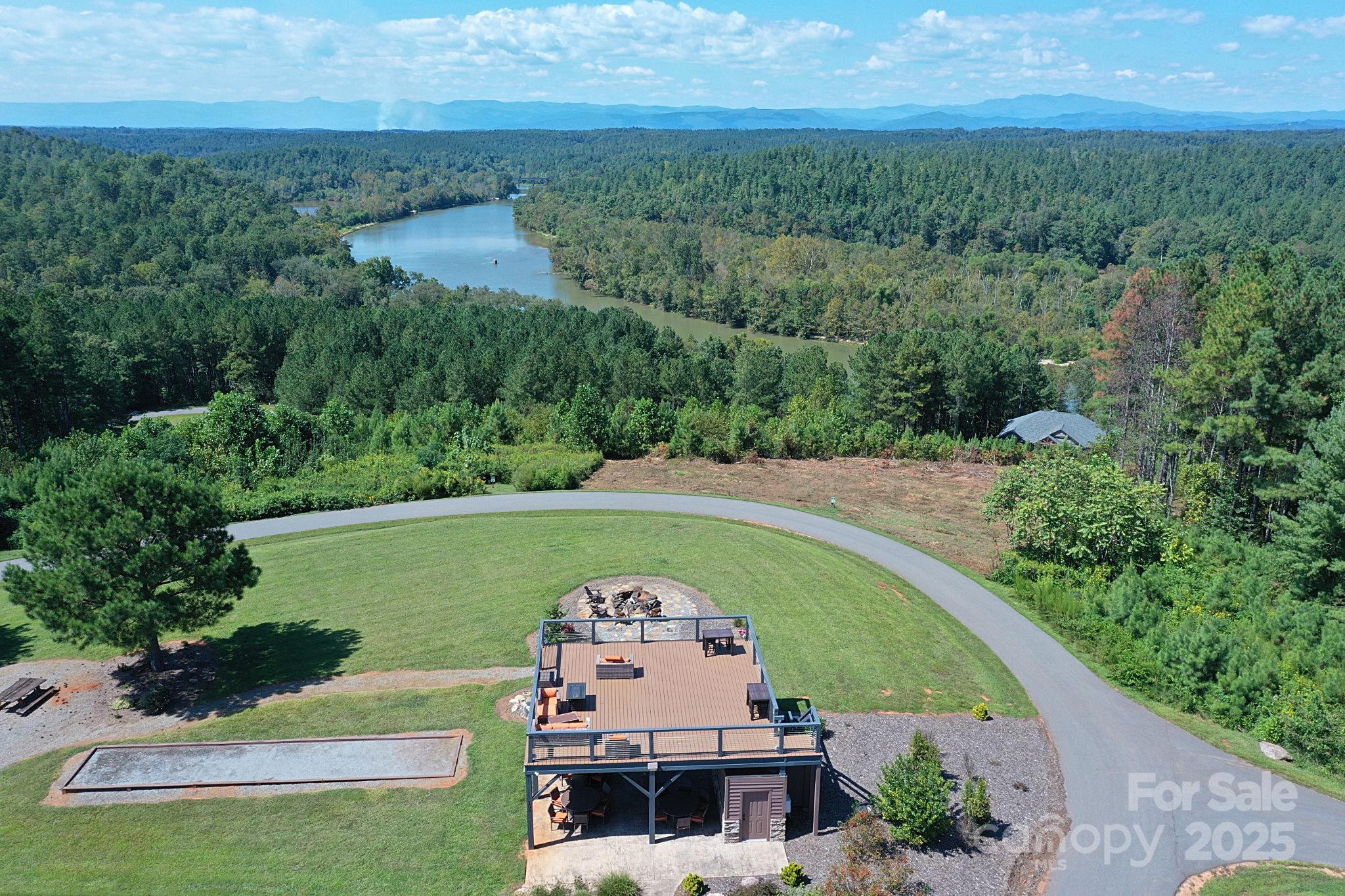 335 Table Rock Trace Northwest, Unit 154 Valdese, NC 28690 - Photo 16 of 25 an aerial view of a house with a garden and trees all around