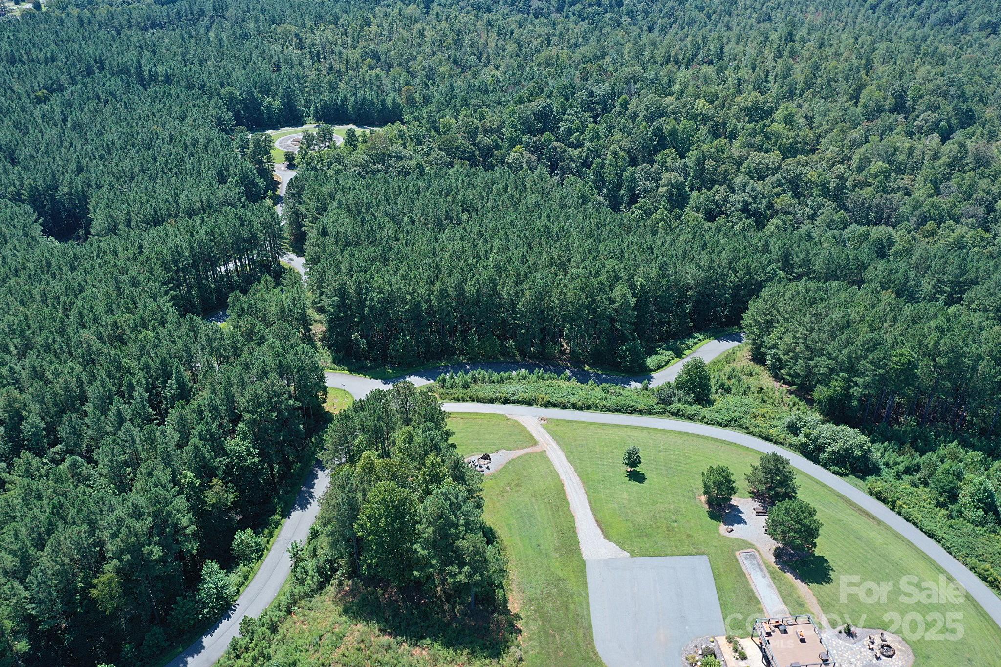 335 Table Rock Trace Northwest, Unit 154 Valdese, NC 28690 - Photo 18 of 25 an aerial view of a house with a yard and lake view