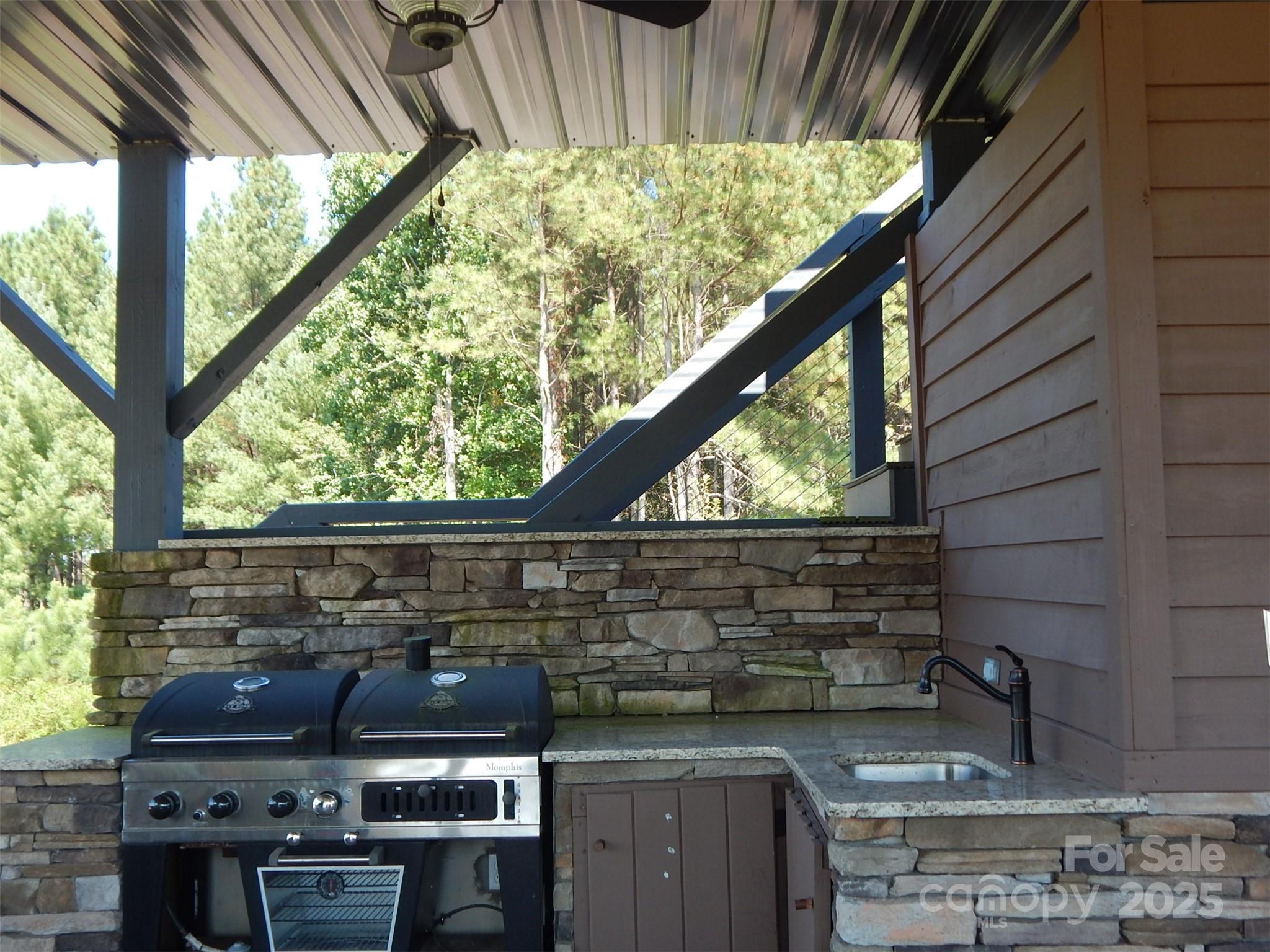 335 Table Rock Trace Northwest, Unit 154 Valdese, NC 28690 - Photo 4 of 25 a stove top oven sitting inside of a kitchen