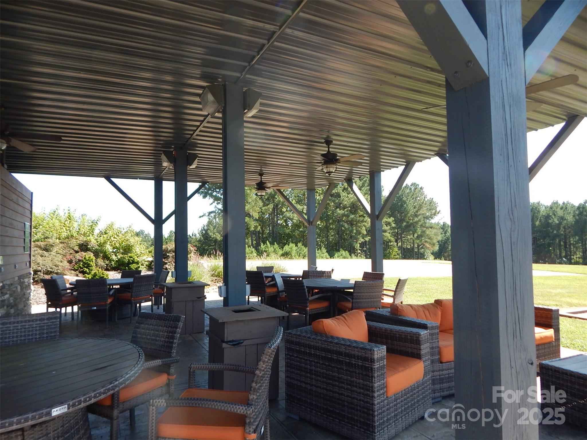 335 Table Rock Trace Northwest, Unit 154 Valdese, NC 28690 - Photo 5 of 25 a outdoor living space with patio furniture and a potted plant