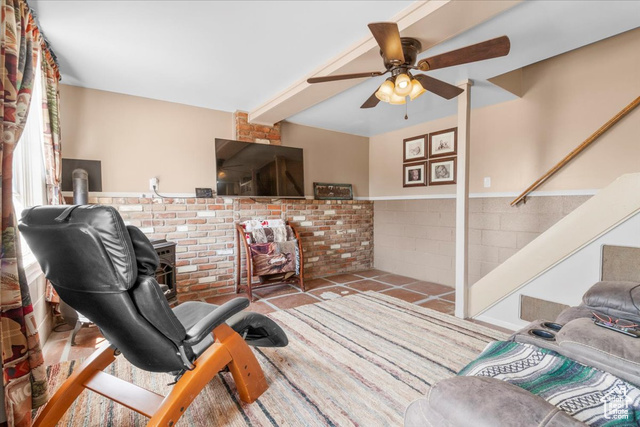 11450 Pigeon Hollow Road Spring City, UT 84662 - Photo 7 of 47 Living room featuring a ceiling fan, stairway, and a wainscoted wall