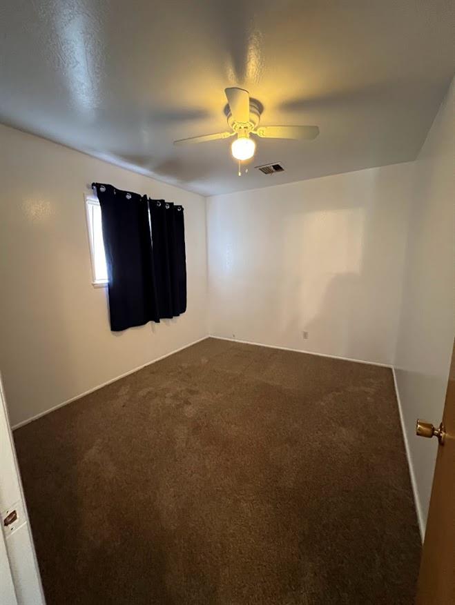 16109 East Manning Reedley, CA 93654 - Photo 23 of 30 an empty room with a chandelier fan and a large window