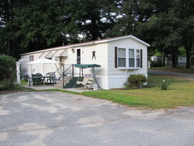 19 R & R Park Dayville, CT 06241 - Photo 1 of 1 a view of a small house in front of a house with large trees