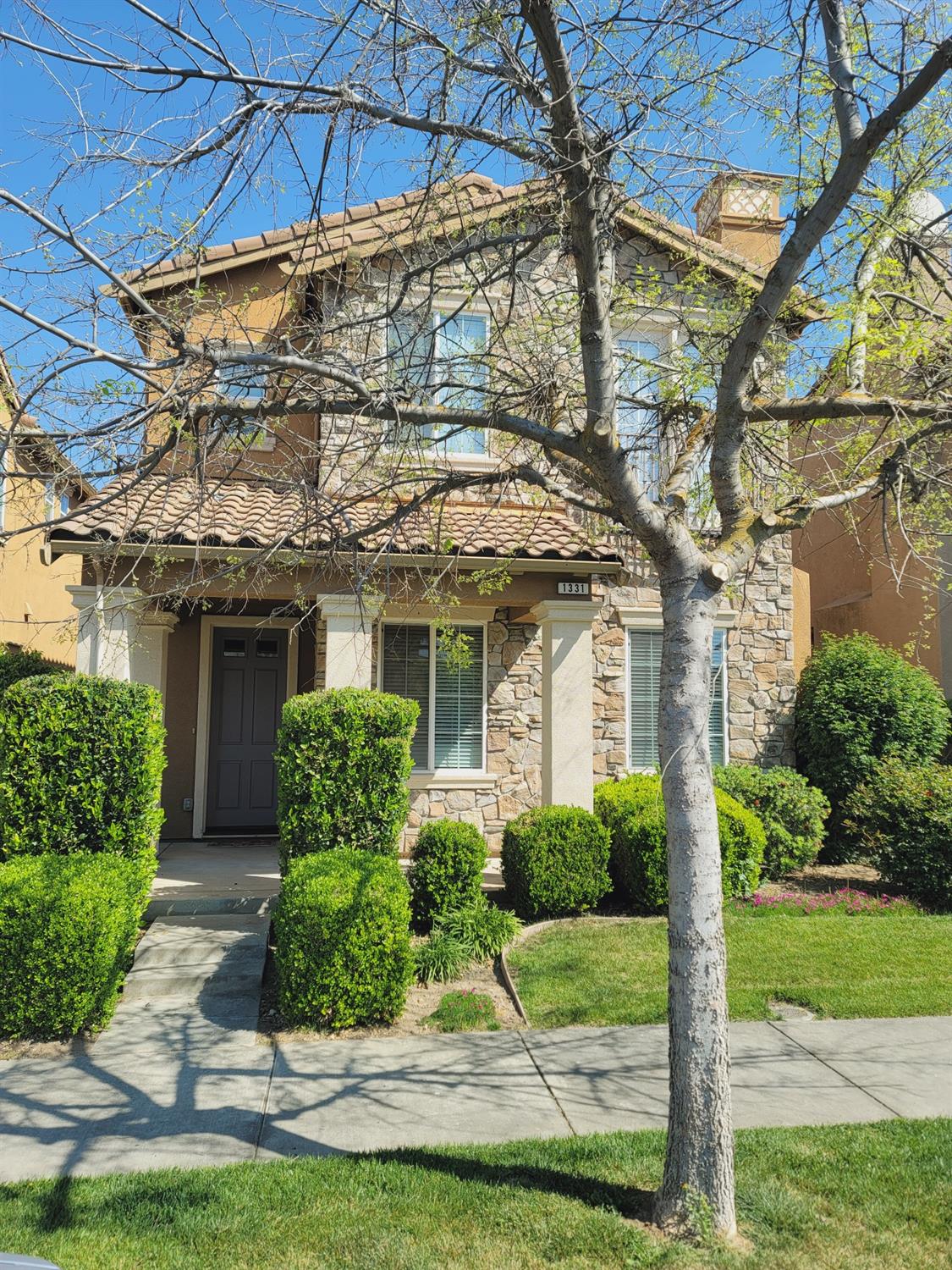 a front view of a house with garden