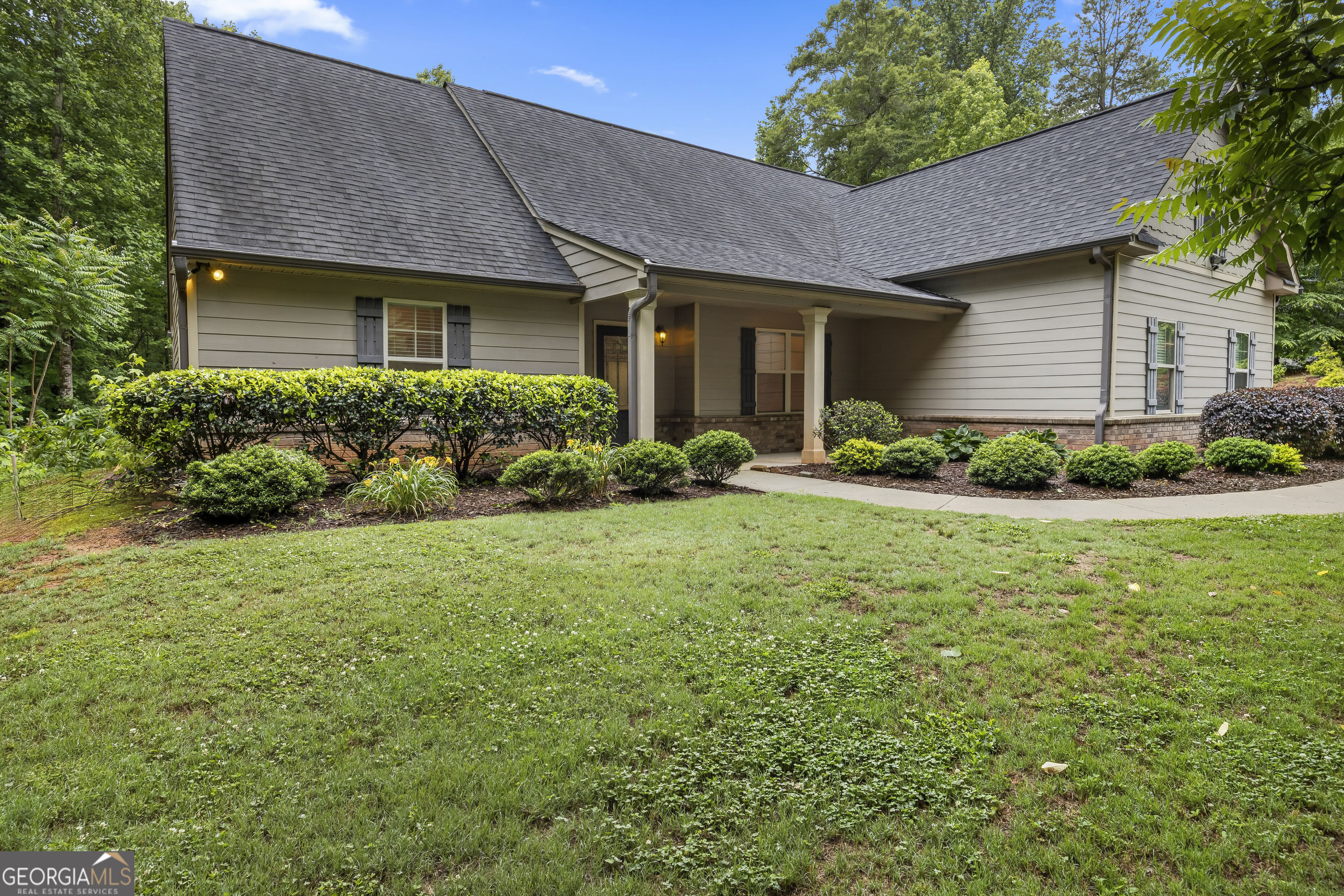 717 Oconee Lane Commerce, GA 30529 - Photo 1 of 57 a front view of a house with garden
