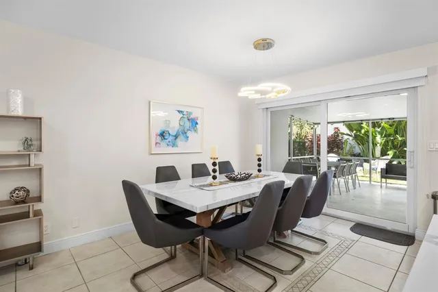 a view of a dining room with furniture wooden floor and a potted plant