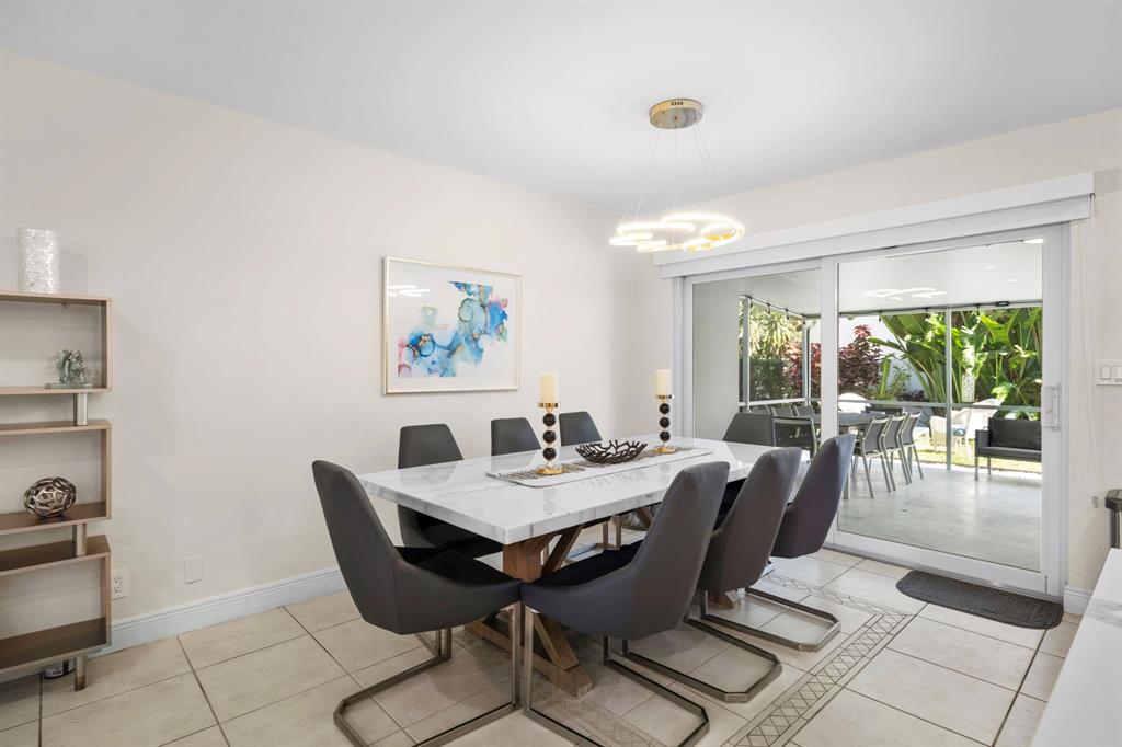 4804-4806 Northeast 21st Avenue Fort Lauderdale, FL 33308 - Photo 13 of 31 a view of a dining room with furniture wooden floor and a potted plant