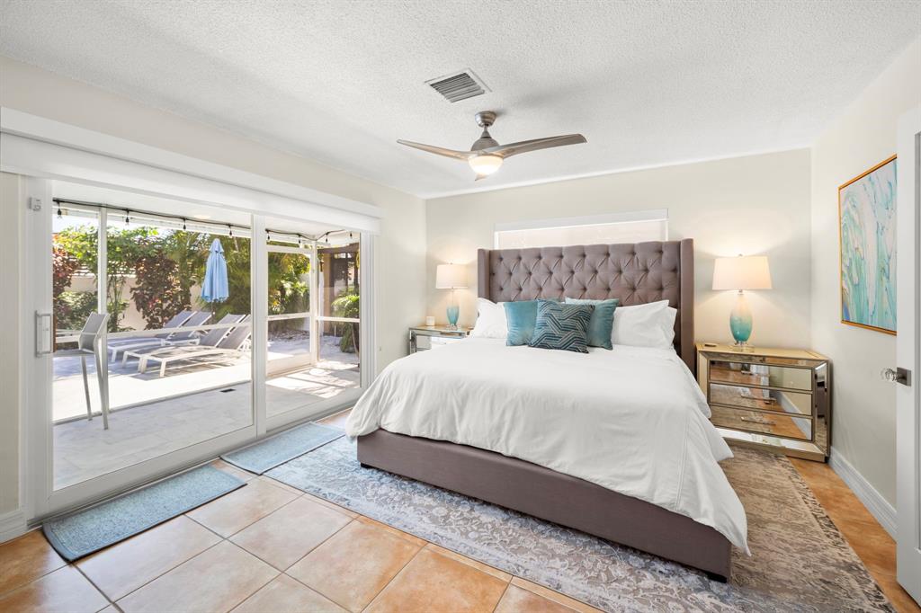 4804-4806 Northeast 21st Avenue Fort Lauderdale, FL 33308 - Photo 16 of 31 a bedroom with a large bed and a large window