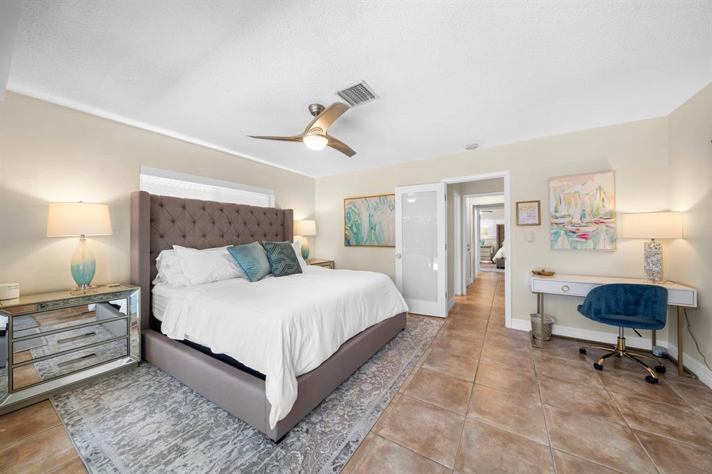 4804-4806 Northeast 21st Avenue Fort Lauderdale, FL 33308 - Photo 17 of 31 a bedroom with a bed a dresser and chair