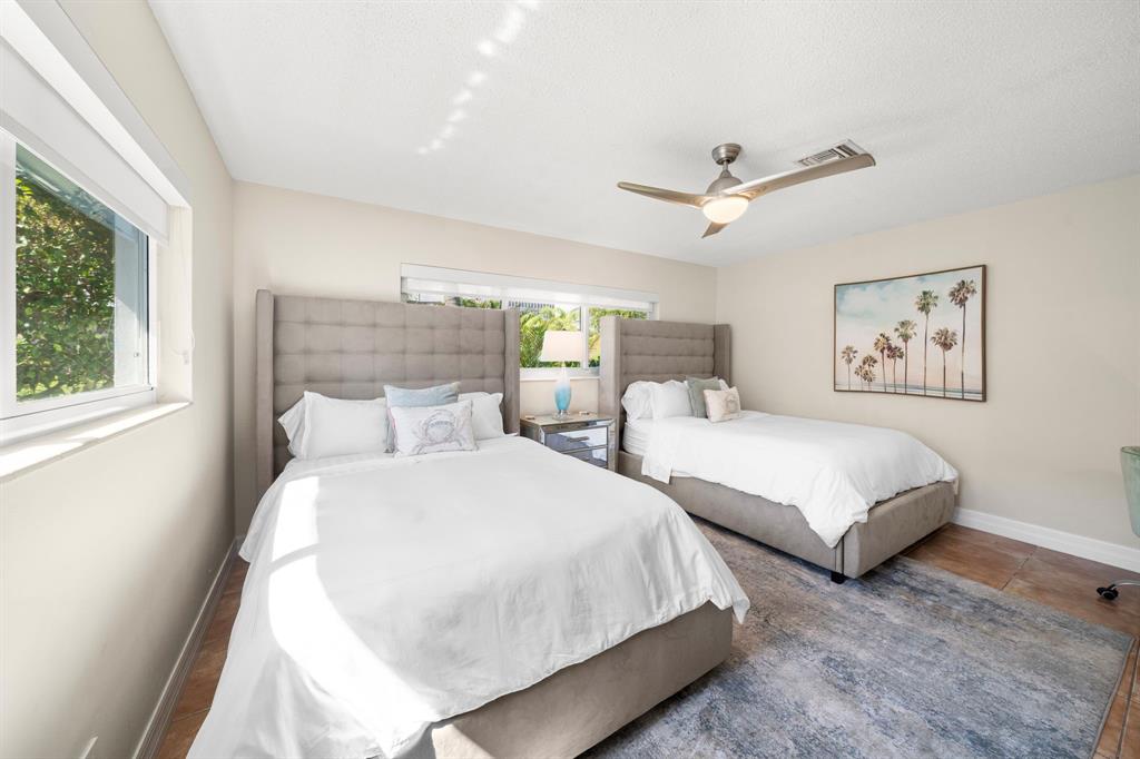 4804-4806 Northeast 21st Avenue Fort Lauderdale, FL 33308 - Photo 19 of 31 a bedroom with two beds and a large window