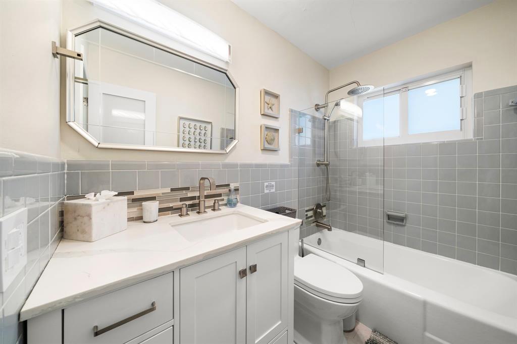 4804-4806 Northeast 21st Avenue Fort Lauderdale, FL 33308 - Photo 20 of 31 a bathroom with a sink a toilet and a mirror