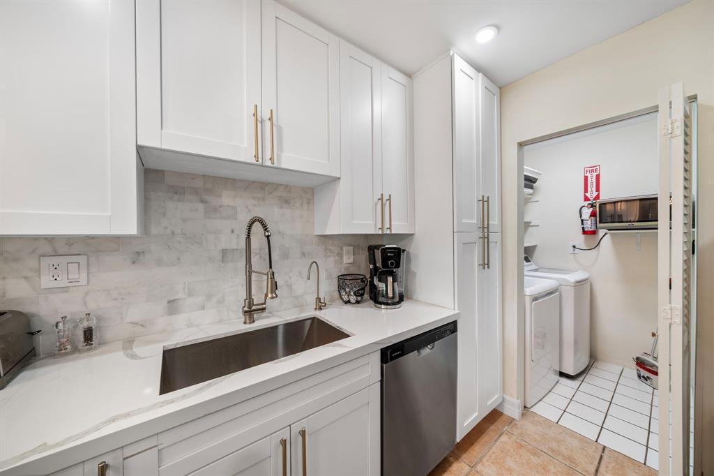 4804-4806 Northeast 21st Avenue Fort Lauderdale, FL 33308 - Photo 23 of 31 a kitchen with stainless steel appliances a sink a refrigerator and cabinets