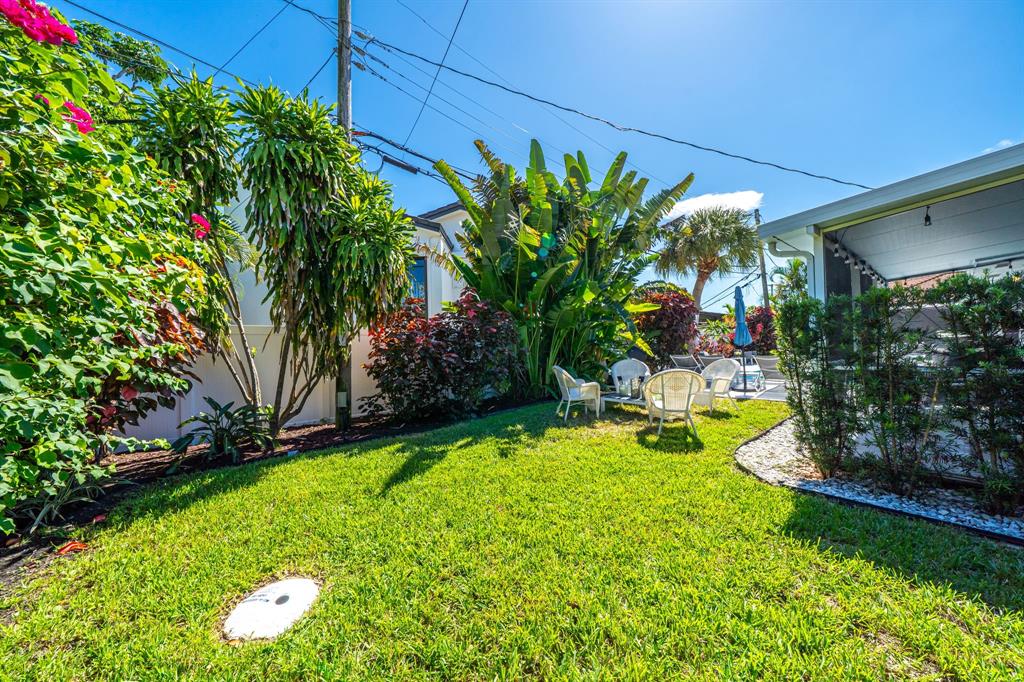 4804-4806 Northeast 21st Avenue Fort Lauderdale, FL 33308 - Photo 27 of 31 a view of a garden with a bench