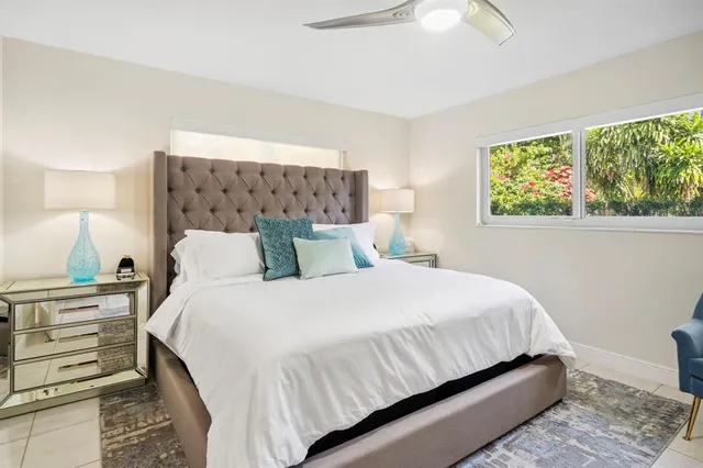 a bedroom with a bed and a painting on the wall