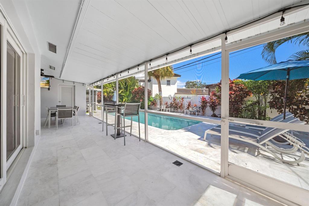 4804-4806 Northeast 21st Avenue Fort Lauderdale, FL 33308 - Photo 31 of 31 a view of a porch with furniture and floor to ceiling window