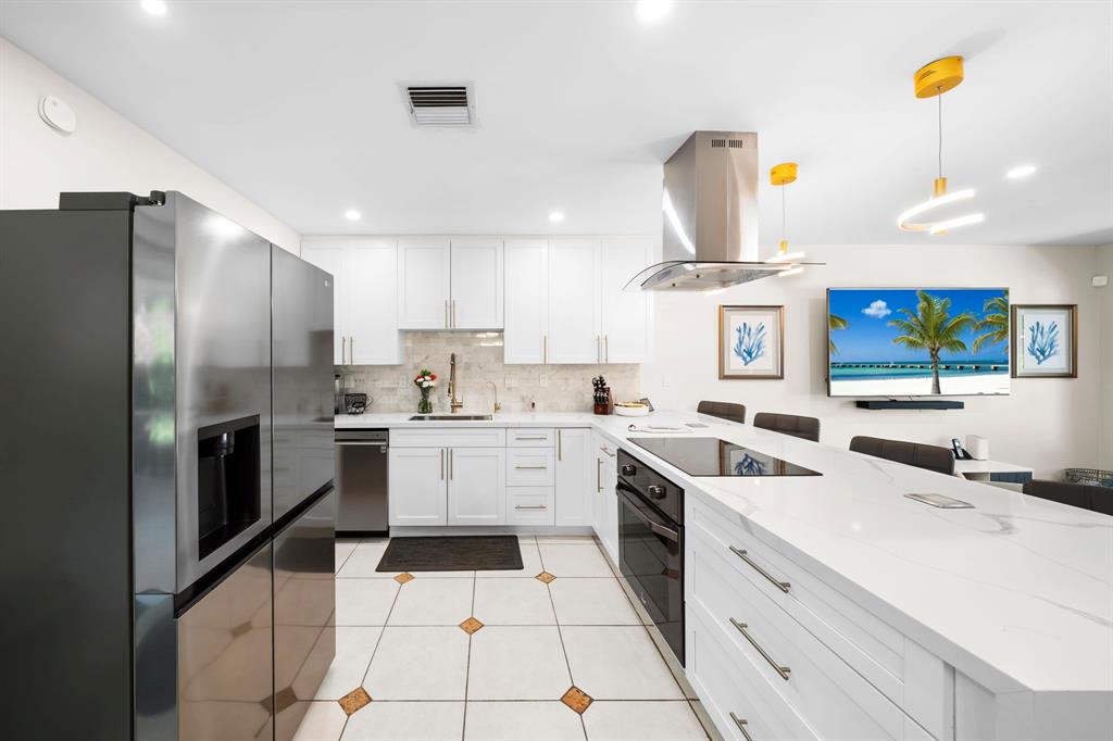 4804-4806 Northeast 21st Avenue Fort Lauderdale, FL 33308 - Photo 9 of 31 a kitchen with a sink stainless steel appliances and cabinets