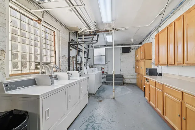 a large white kitchen with a large window