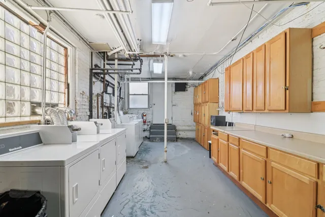 a large white kitchen with a large window