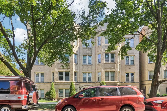 a front view of a multi story building with yard