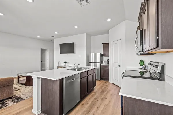 a kitchen with a sink stove and refrigerator