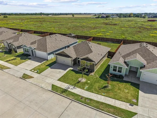 an aerial view of a house with a ocean view