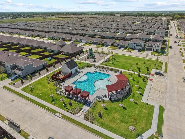 an aerial view of residential houses with outdoor space