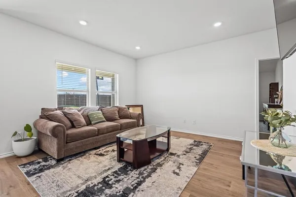 a living room with furniture and wooden floor