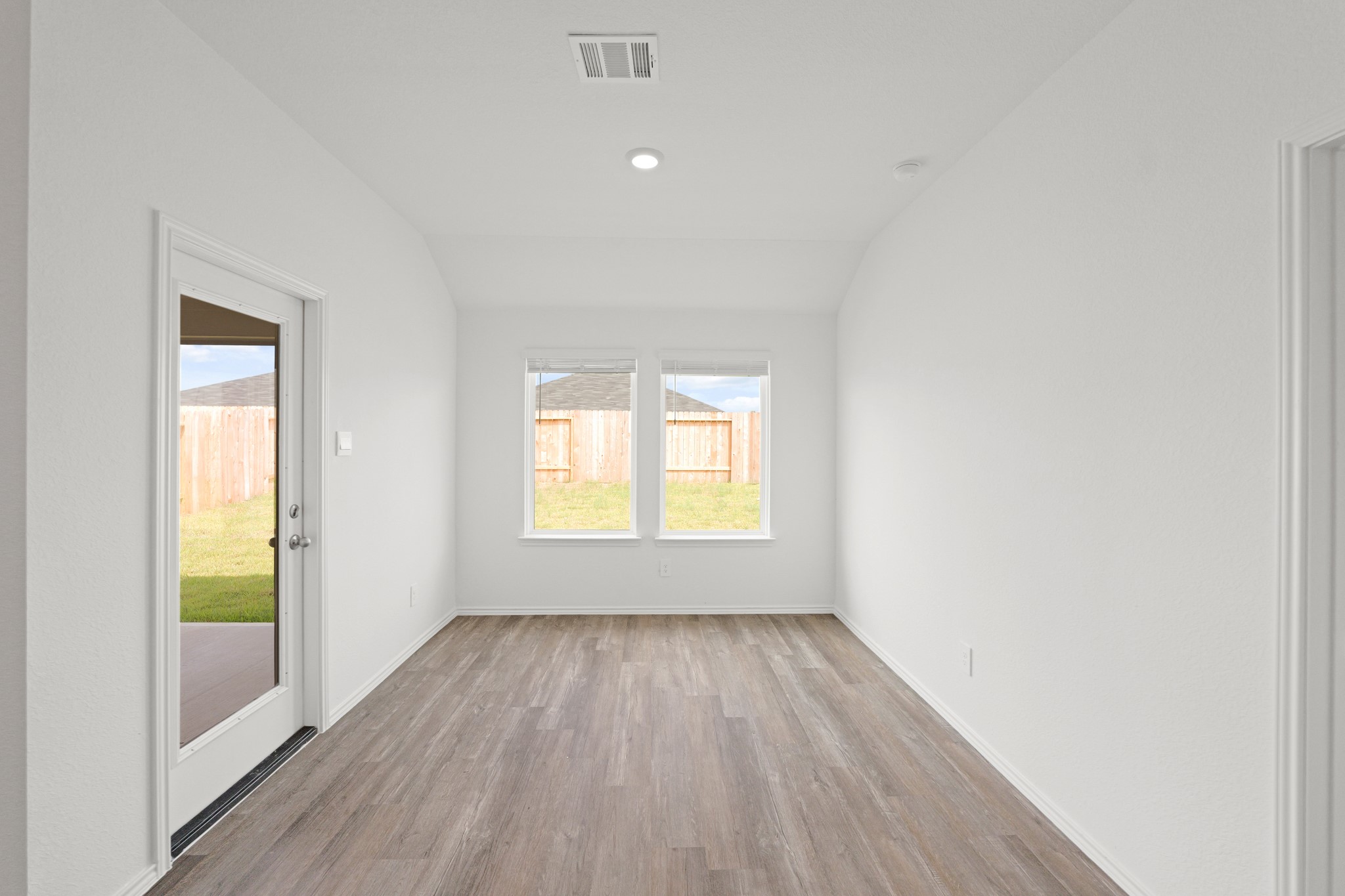 14392 Oceanblue Way Splendora, TX 77372 - Photo 11 of 30 wooden floor in an empty room with a window