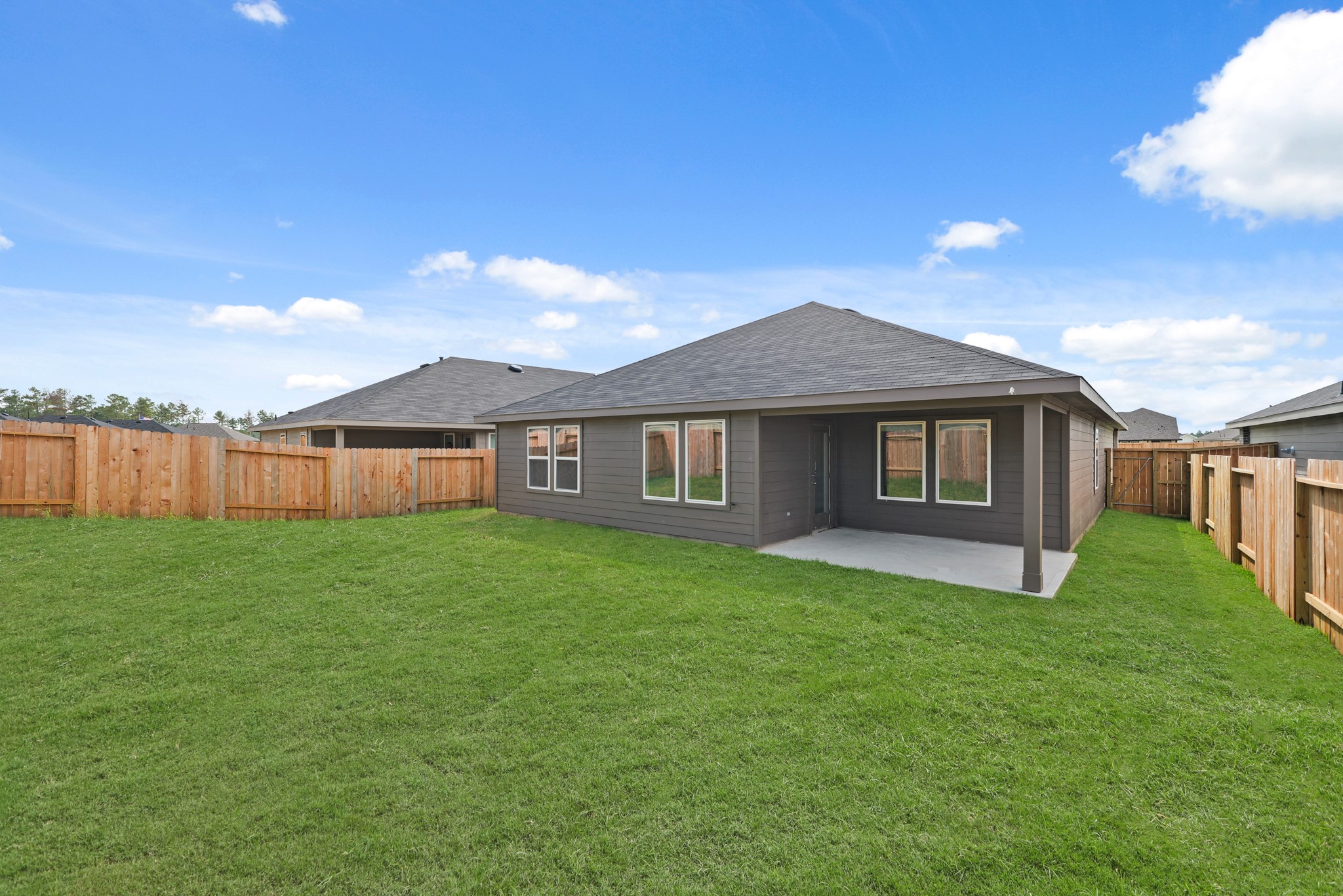 14392 Oceanblue Way Splendora, TX 77372 - Photo 20 of 30 a view of a yard in front of a house with a yard